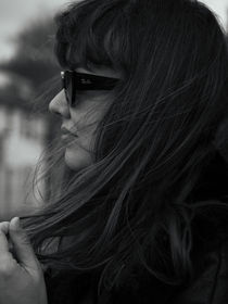 Black-and-white side-profile portrait of a woman in sunglasses