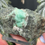 Thumbnail: Natural Rough Emerald in Matrix with Epidote Growth on Glass Display Stand