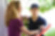 Image shows a man dropping off a flower delivery.