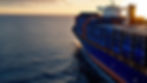 A cargo ship at sea. The color of the containers on the cargo ship will be Deep Blue
