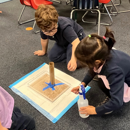 Kindergarten students engaged in classroom science project.