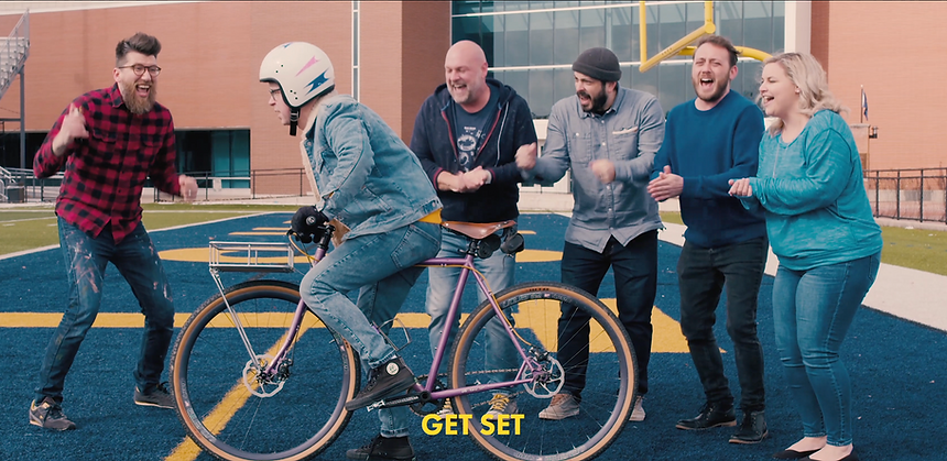 people cheering man on bike