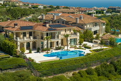 Drone photo of ultra luxury listing in Crystal Cove, Newport Coast on a sunny day.