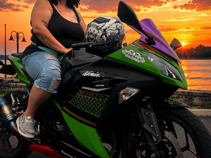Angelique sitting on a green motorcycle accessibility.