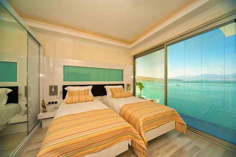 Modern bedroom with integral blinds and ocean view