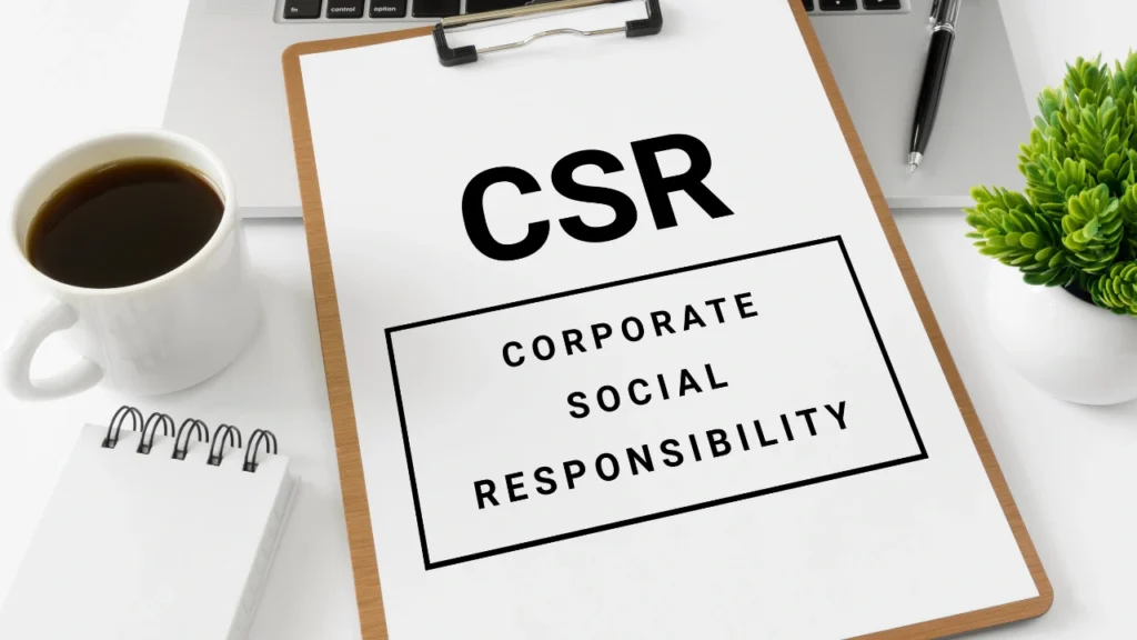 CSR document on clipboard with office desk items.