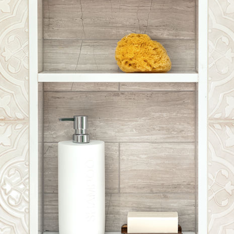 Bathroom remodel detail in Somerville MA with built-in shower niche and marble-style tile by Morse Constructions