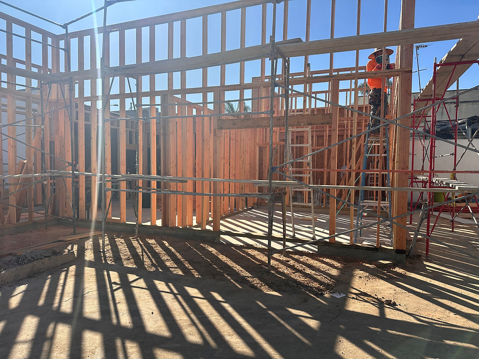 Standing in future garden facing MAKE's very first own classroom