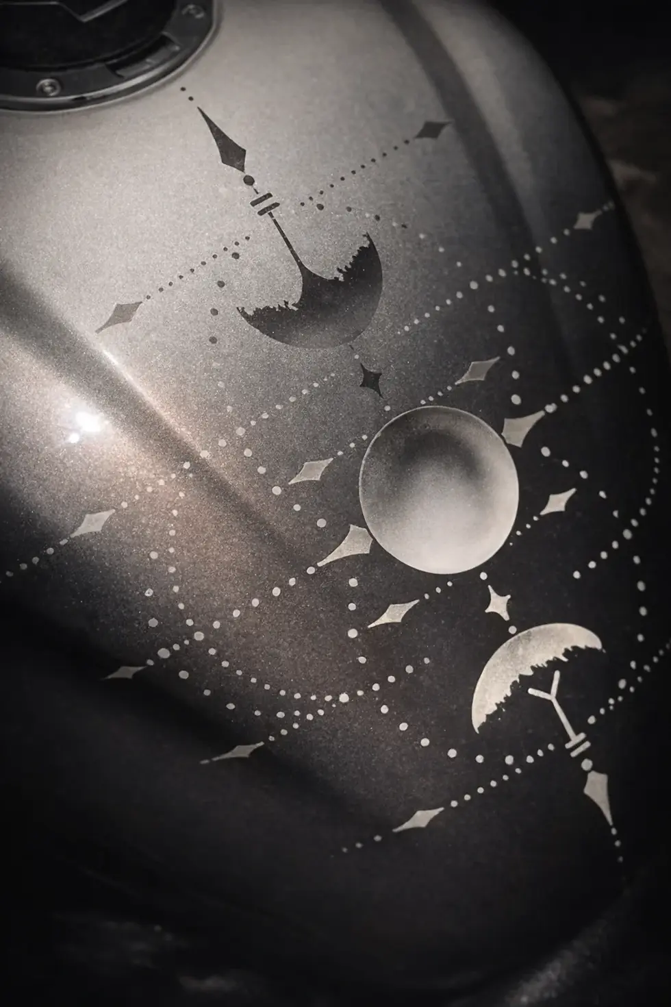 Motorcycle bodywork with monochrome celestial design and airbrushed tattoo-inspired artwork