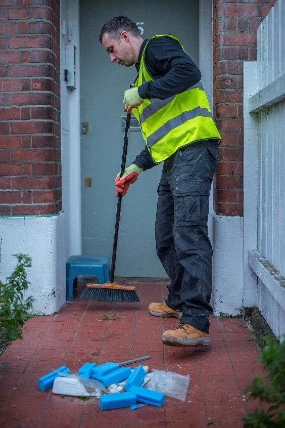 creative-waste-solutions-ltd-crew-member-in-high-vis-clearing-messy-floor-with-contruction