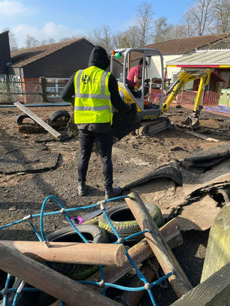 sales-executive-kieran-carries-playground-pieces-to-skip-as-part-of-a-local-community-clea