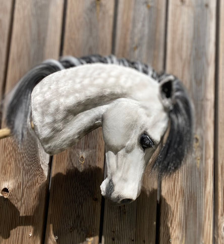 Handcrafted dapple grey hobby horse with lifelike features, poseable ears, and realistic shading, inspired by real horse anatomy