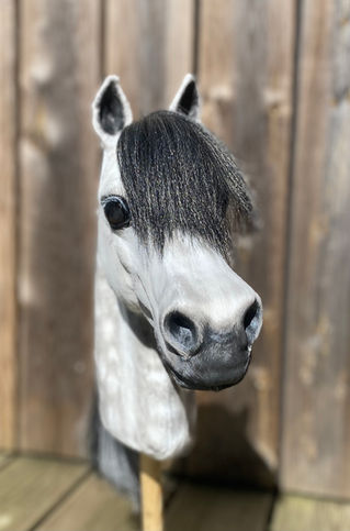 Realistic handmade dapple grey hobby horse with lifelike details, including hand-painted dapples, expressive eyes, soft plush coat, and natural black-and-grey mane, handcrafted as a unique Moody Mare.