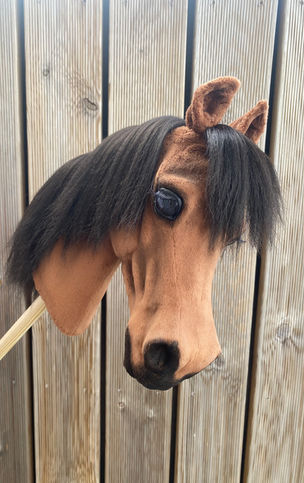 Realistic handmade bay hobby horse with black mane and lifelike facial details customized by Moody Mare.
