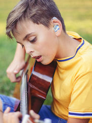 Boy strumming guitar