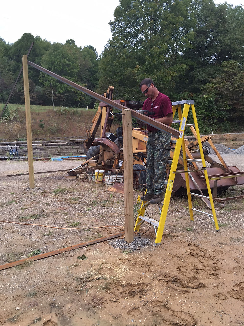 Jim installing lag bolts into the vertical supports.