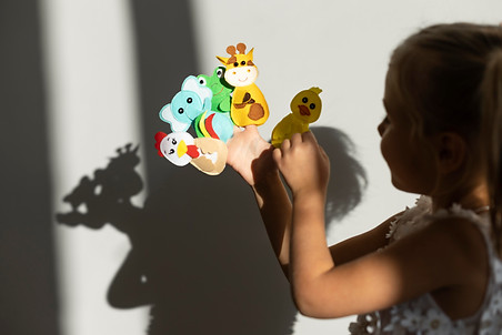 adorable-little-girl-playing-with-her-puppets-home.jpg