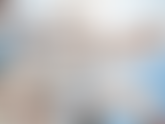 Cherry blossoms in full bloom against a bright blue sky. Soft pink and white petals create a serene and peaceful atmosphere