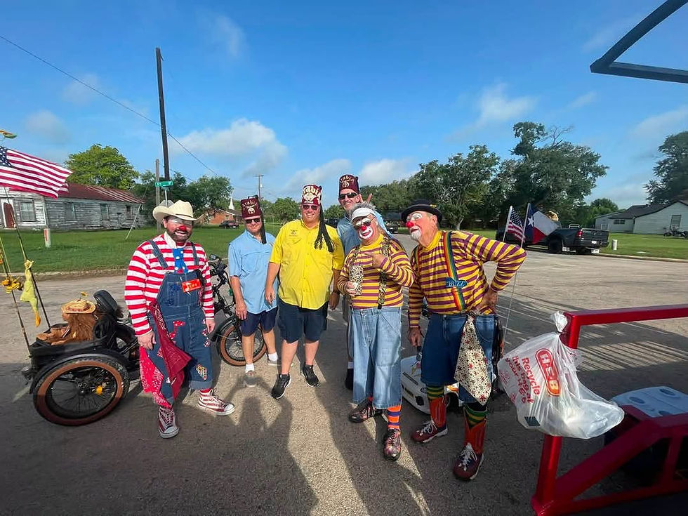 Wide-angle view of cheerful clowns entertaining children along a parade route.