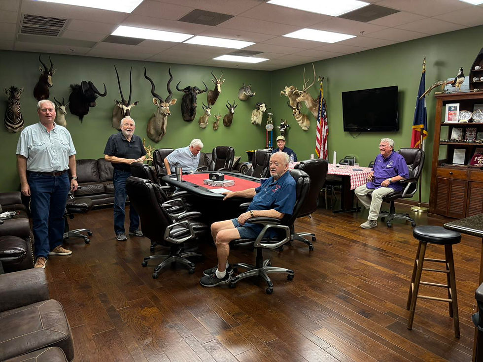 Eye-level view of a group of men gathered around a table playing poker in a cozy room