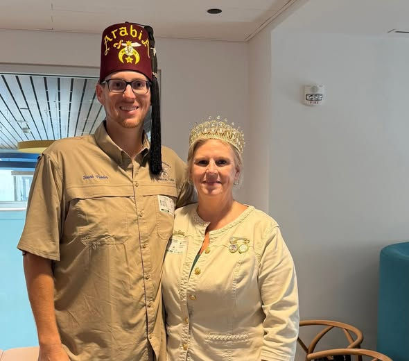 Close-up view of Queen Liz Trader handing an Easter basket to a child