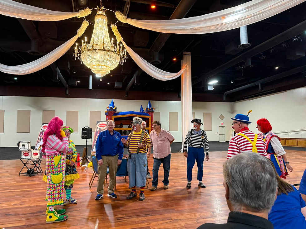 Low-angle view of circus performers entering a lit ring.