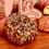 Thumbnail: Everything bagel in front of rye sandwich bread, sourdough, challah, and a chocolate croissant.