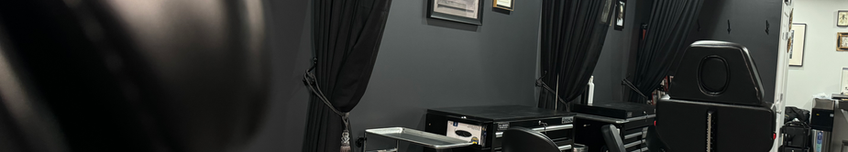 Urban-chic tattoo studio with exposed brick walls and contemporary art, blending comfort with style.