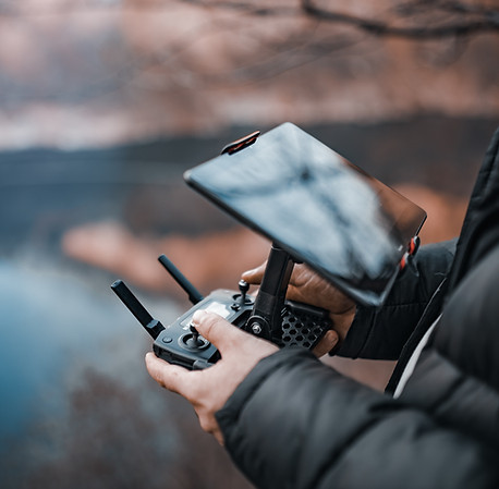 person-controlling-drone-near-a-body-of-water-2026-03-18-04-20-14-utc
