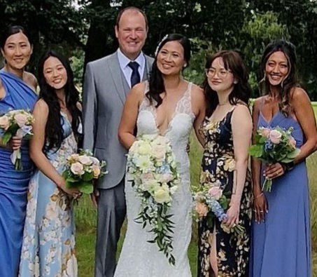Bride with her bridesmaids and family after bridal party makeup and hair