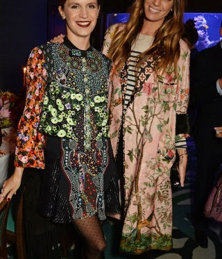 Two guests with long waves and evening makeup at a London event