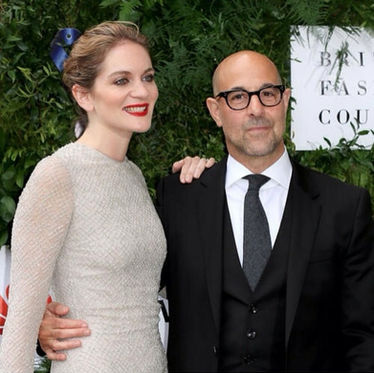 Stanley Tucci and Felicity Blunt at a British Fashion Council event, with a red lip and elegant updo
