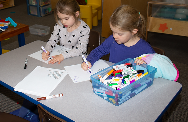 students coloring accepting admission forms Catholic school Holy Family School Albany MN