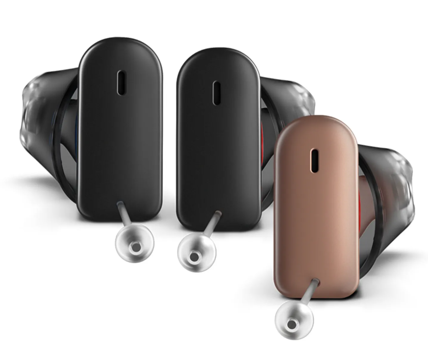 Nearly invisible hearing aid worn inside ear canal during conversation