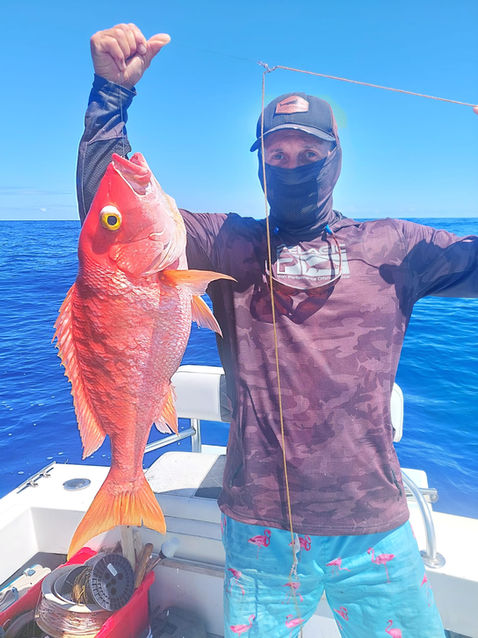 Angler proudly displays a large red snapper