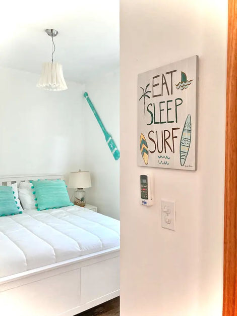 Beachy bedroom with Eat Sleep Surf art