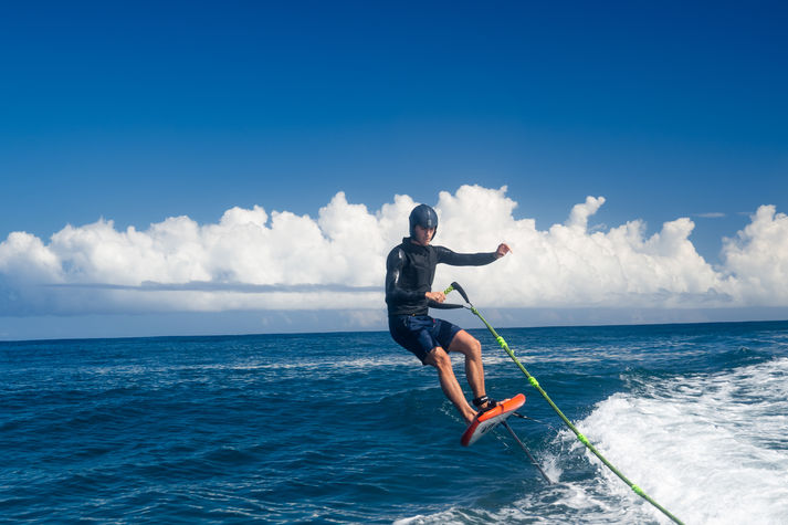 Man hydrofoiling on ocean wave
