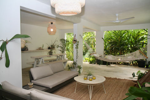 Relaxing patio with hammock, sofa, and plants