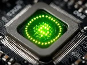 Close-up macro photo of a GPU chip with a glowing green light, showing the intricate details of its electronic circuits and metallic connectors.