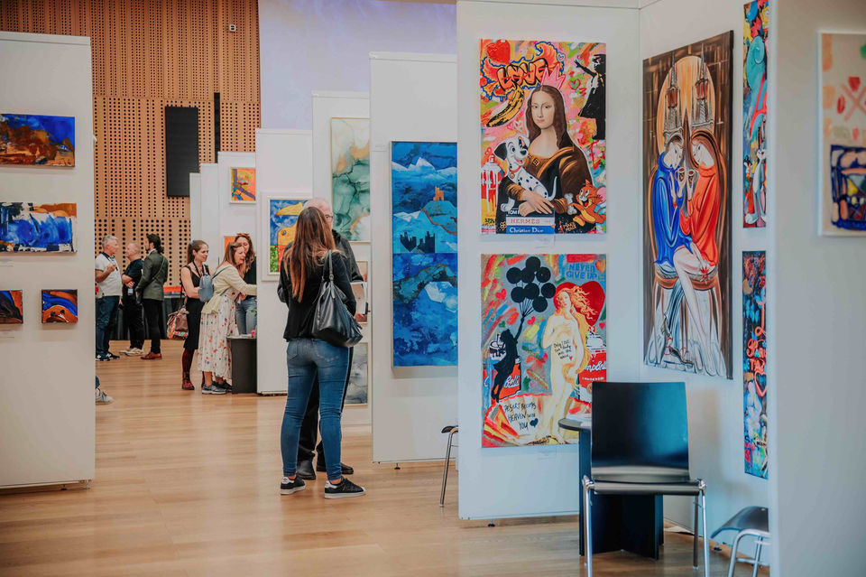 Visitors looking at artworks during ART Expo Ljubljana