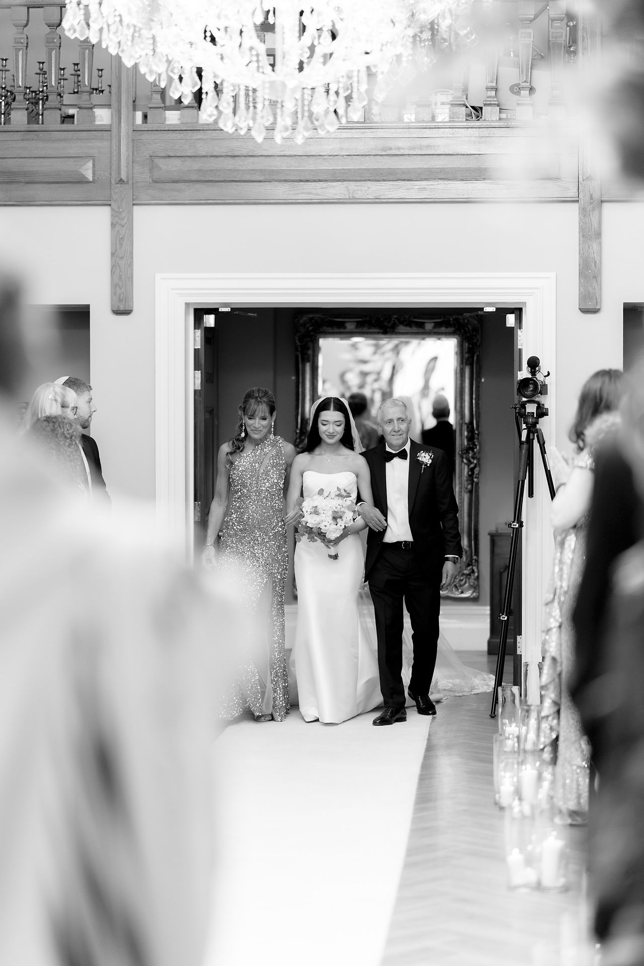 Rushton Hall wedding with bride and parents walking down the isle
