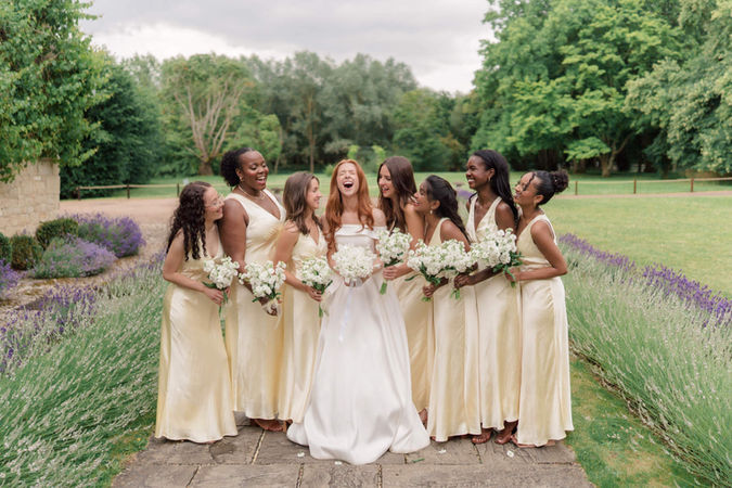Bride laughing with her bridesmaids