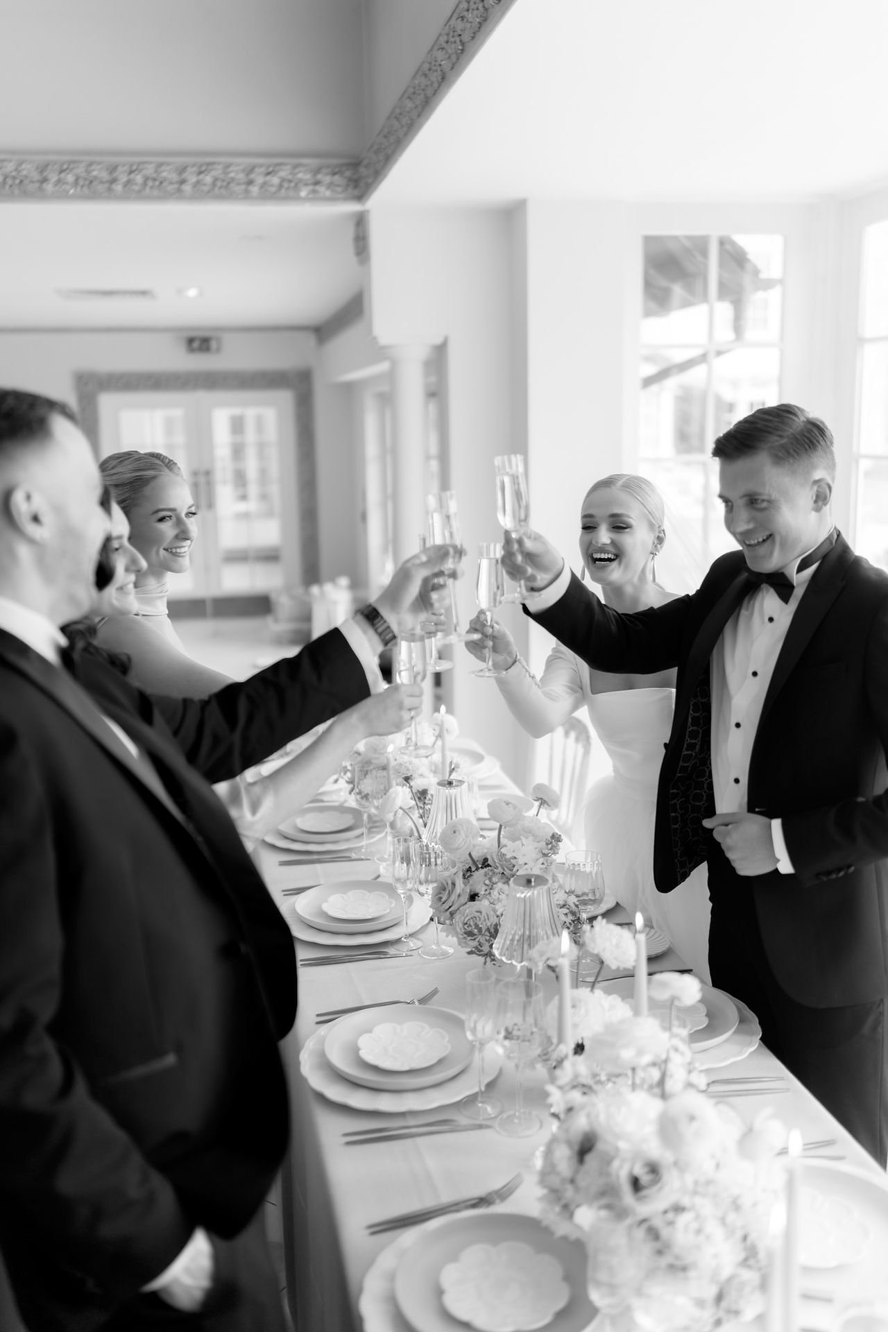 Wedding guests toasting at table at Froyle Park Wedding