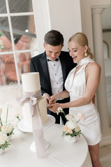 Froyle Park Wedding bride and groom cutting the cake together 