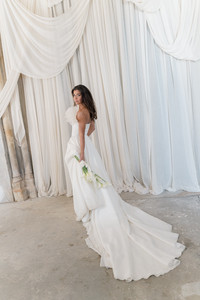 bride walking with her bouquet at wedding at Elvetham hotel
