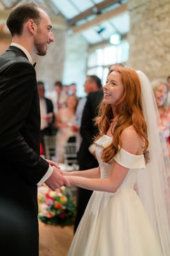 Bride and groom exchanging wedding rings