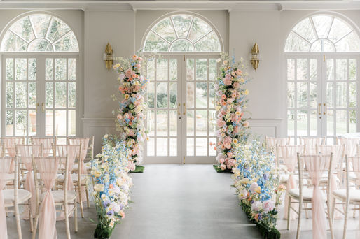 The Orangery wedding photographer with ceremony flowers in light colour