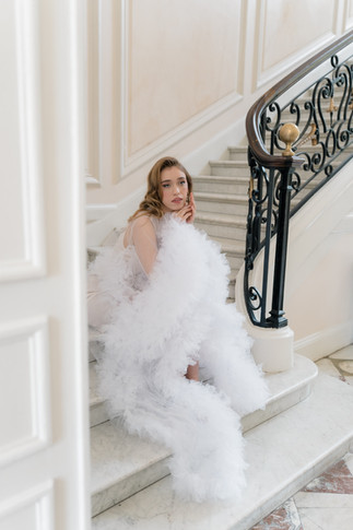 Bride sitting on stairs for Chateau De Santeny Wedding Photographer