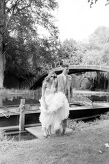 Bride and groom walking together getting of boat at Avington wedding 