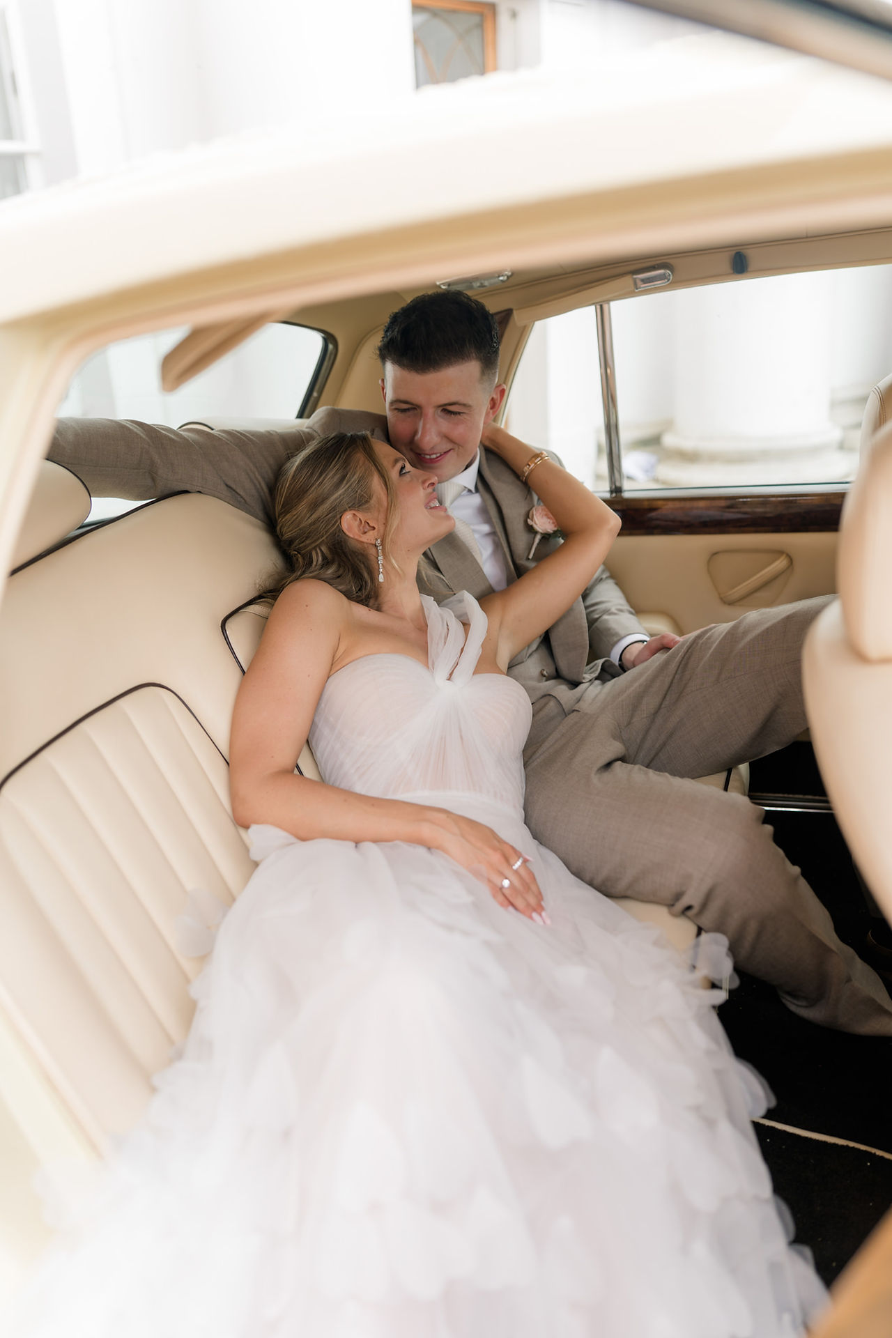 Avington wedding with bride and groom sitting gin car together